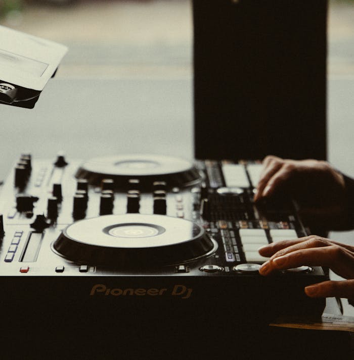 Close-up of Person Hands Playing on DJ Mixer